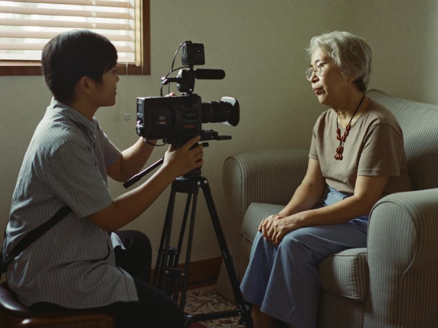 Our videographer listening to a senior in her living room